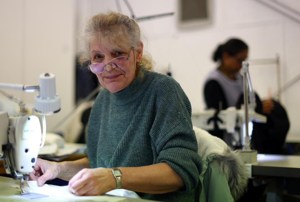 Machinist Yasemin Mehmet, aged 68, poses for a photograph on the factory floor of Fashion-Enter Ltd in London, Britain, February 15, 2023. REUTERS/Hannah McKay