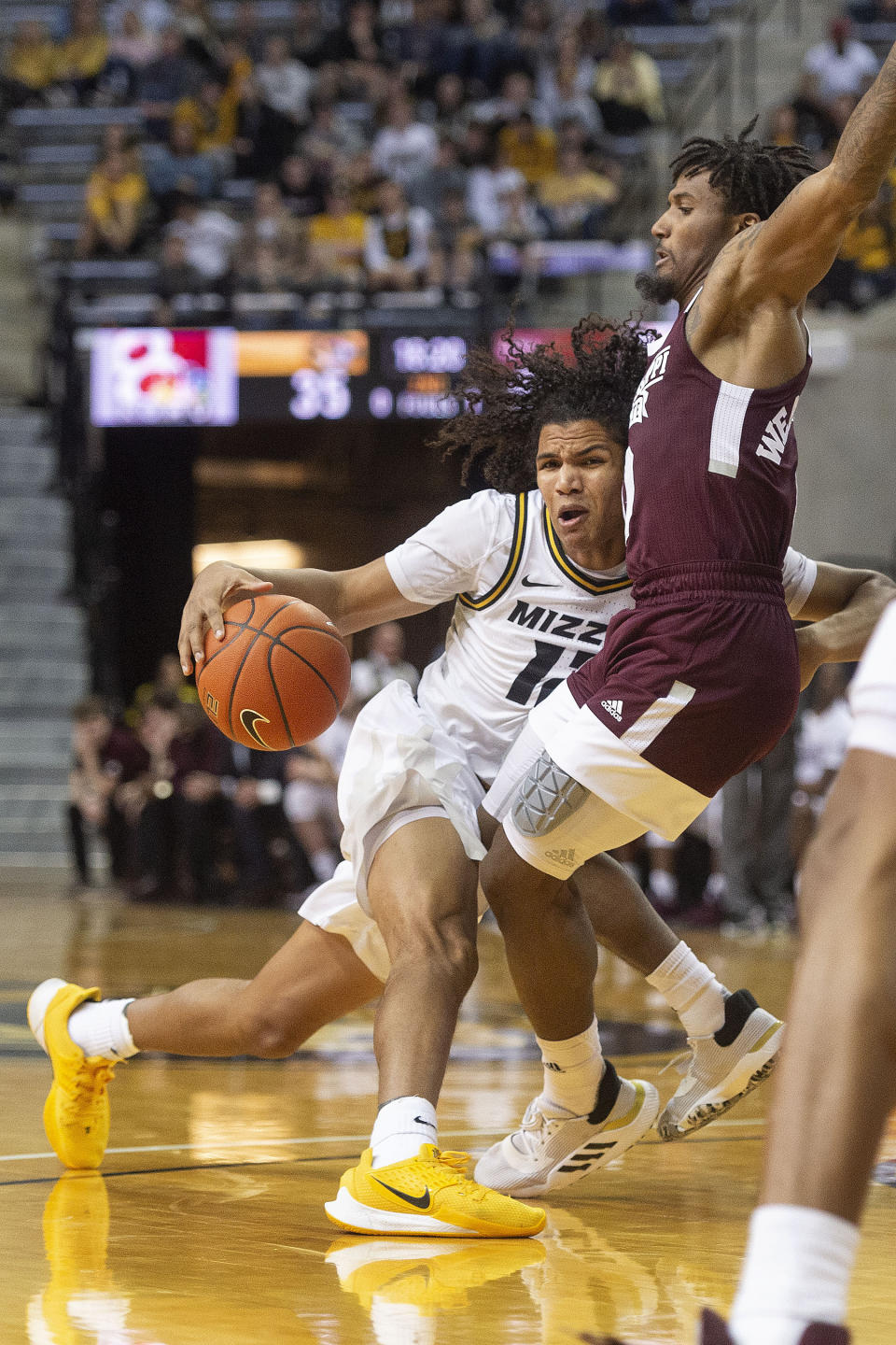 Missouri's Dru Smith, left, dribbles into Mississippi State's Nick Weatherspoon, right, during the second half of an NCAA college basketball game Saturday, Feb. 29, 2020, in Columbia, Mo. Mississippi State won 67-63. (AP Photo/L.G. Patterson)