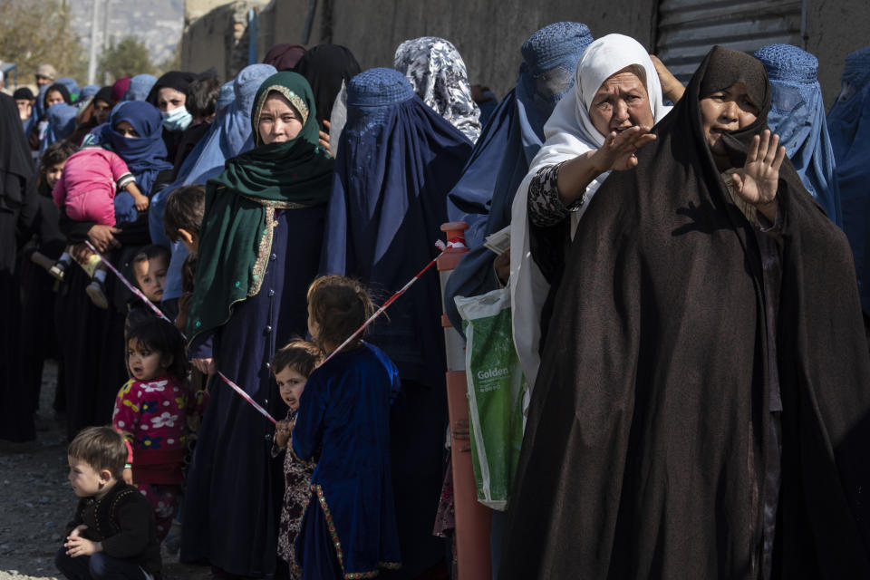 Afghans wait in line.