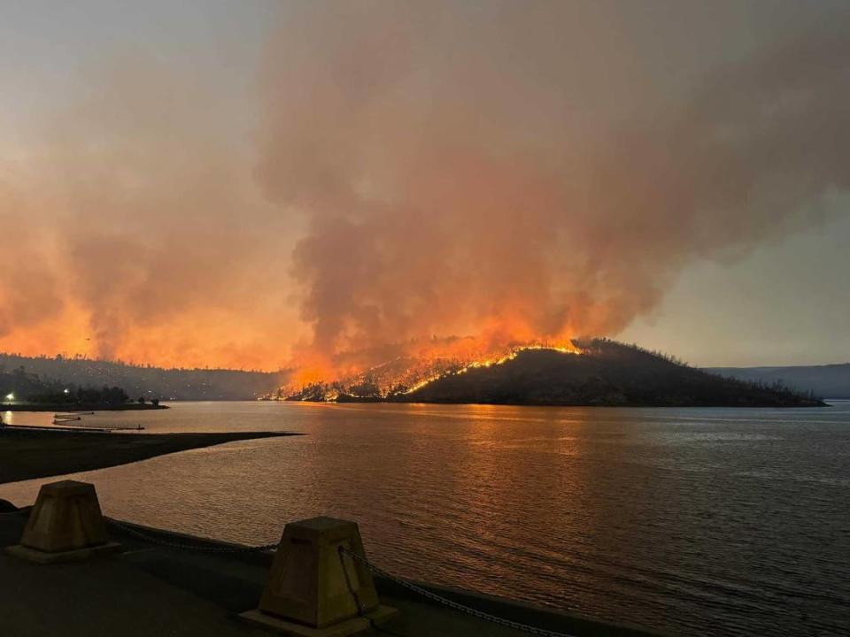 Flames are seen on the shores of Lake Oroville from the Thompson Fire on Tuesday, June 2, 2024. The 3,000-acre wildfire has prompted evacuations of roughly 13,000 residents in Butte County.