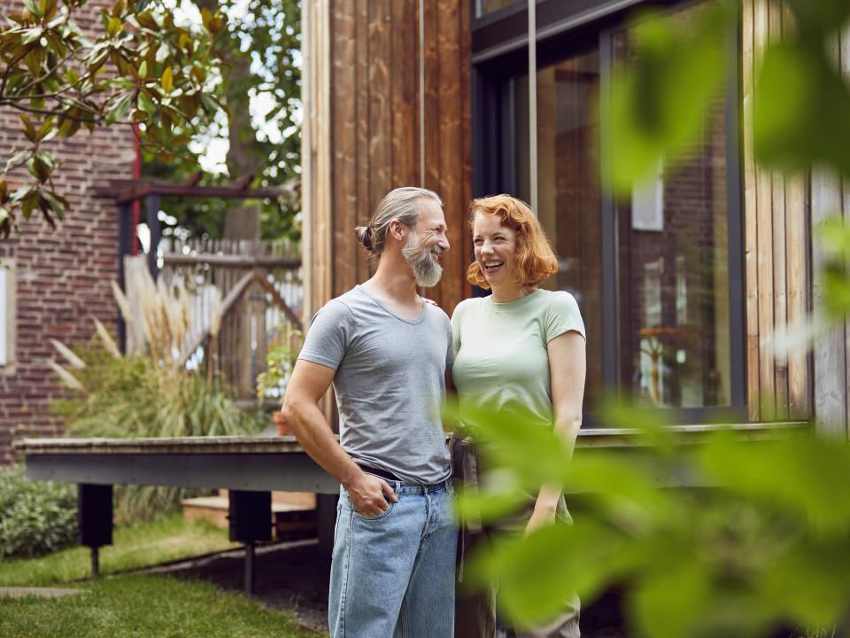 A couple in front of their new home.