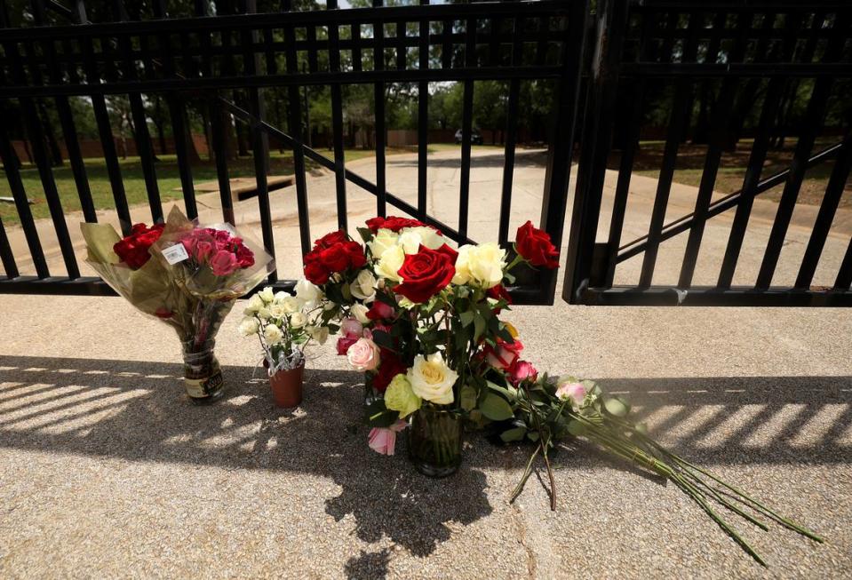Flowers sit at the gate to the Monastery of the Most Holy Trinity, where the Discalced Carmelite Nuns of Arlington live and pray, on Wednesday, May 31, 2023. Supporters of the sisters placed the flowers outside the monastery after praying at a nearby park. Michael Olson, the Bishop of Fort Worth, has suspended daily activities, including mass and confession.