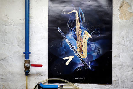 A poster with a saxophone and a clarinet is pictured at the Henri Selmer wind instruments factory in Mantes-la-Ville near Paris, France, January 17, 2018. REUTERS/Benoit Tessier