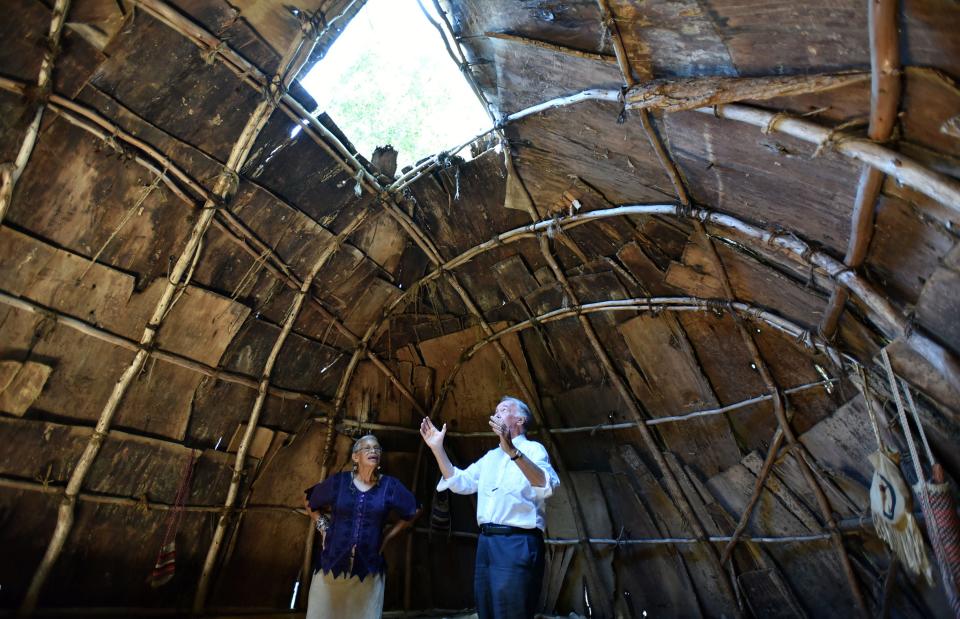 Anita "Mother Bear" Peters shows U.S. Sen. Edward Markey a wetu on Tuesday in Mashpee during Markey's visit with state Sen. Susan Moran to the Mashpee Wampanoag Museum and several other tribal locations.