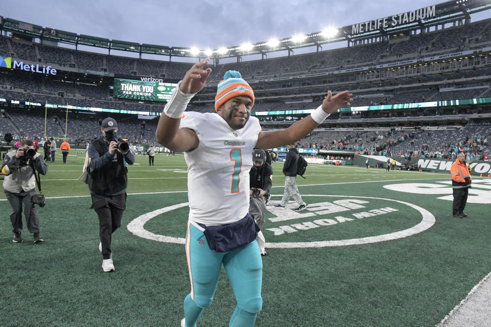 Miami Dolphins quarterback Tua Tagovailoa celebrates as he leaves the field after an NFL football game against the New York Jets, Sunday, Nov. 21, 2021, in East Rutherford, N.J. (AP Photo/Bill Kostroun)