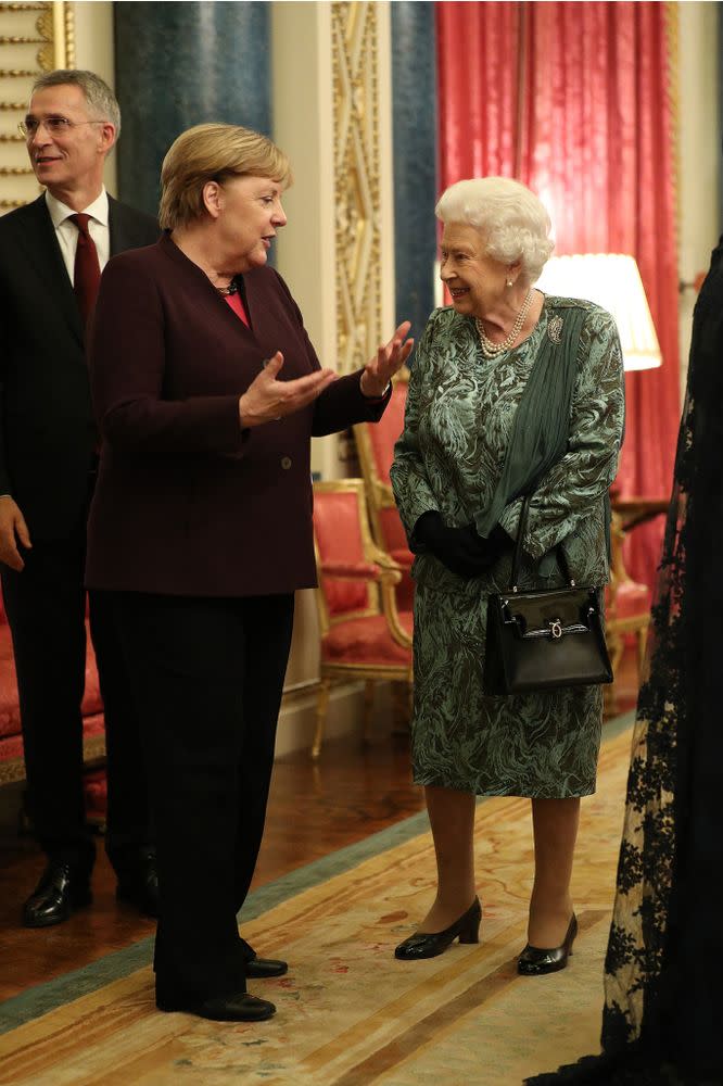 Chancellor of Germany Angela Merkel talks to Queen Elizabeth at a reception for NATO leaders at Buckingham Palace