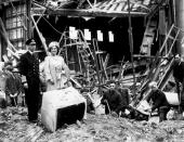 <p>King George VI and Queen Elizabeth survey the damage at Buckingham Palace after it was bombed during World War II.</p>