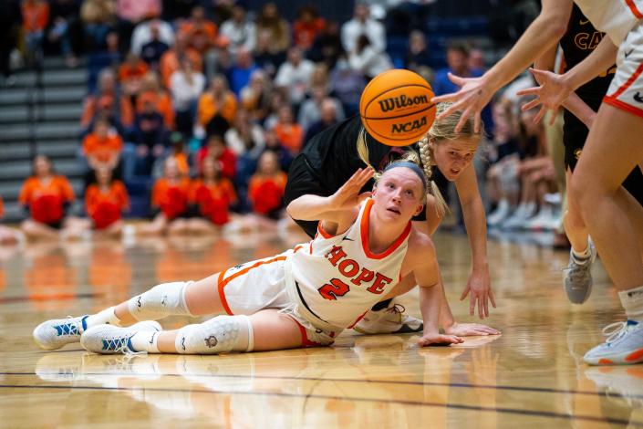 Hope's Meg Morehouse passes the ball to a teammate to keep possession Wednesday, Feb. 8, 2023, at DeVos Fieldhouse. 