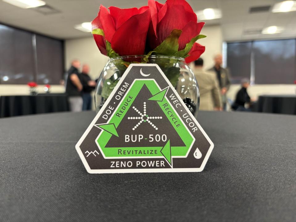 An original badge created by Zeno carries the name of the Oak Ridge generator, the partners who helped transport it safely, and symbols for the arctic, lunar and oceanic places Zeno's systems will power.