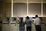 Chinese investors use computer terminals as they monitor stock prices at a brokerage house in Beijing, Tuesday, Nov. 19, 2019. Asian shares were mixed Tuesday as investor sentiment remained cautious amid worries about the next development in trade talks between the United States and China. (AP Photo/Mark Schiefelbein)