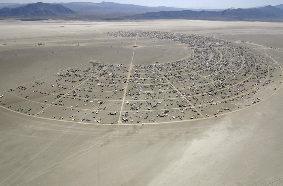 FILE - Black Rocky City begins to grow during the opening of Burning Man Sunday, Aug. 27, 2006, in Gerlach, Nev. Burning Man organizers don't foresee major changes in 2024 thanks to a hard-won passing grade for cleaning up this year's festival. Despite the successful inspection, debate continues over whether the 30-year-old gathering has grown too big. Some question whether it has veered too far from its core principles of radical inclusion and participation. (AP Photo/Ron Lewis, File)