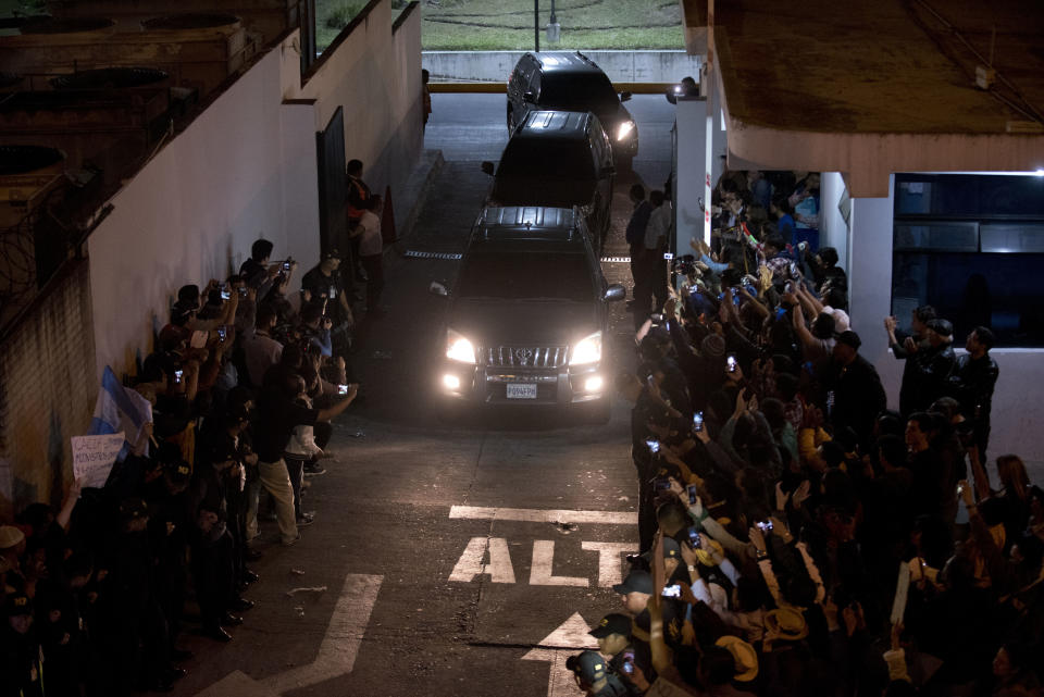 A caravan carrying Colombian national Yilen Osorio, a member of the International Commission Against Impunity in Guatemala (CICIG) leaves the La Aurora International Airport in Guatemala City, Sunday, Jan. 6, 2019. Authorities in Guatemala were holding Osorio, a member of the U.N.-sponsored anti-corruption commission in the capital's airport on Sunday, refusing him entry to the country in an escalation of tensions between the government and the commission. (AP Photo/Santiago Billy)