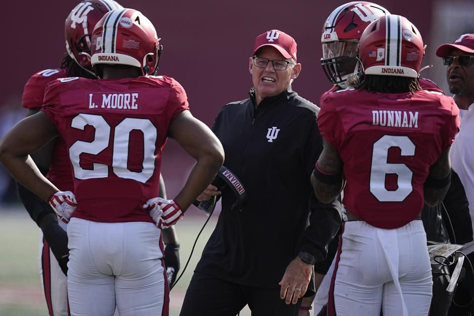 Indiana head coach Tom Allen talks with the defense during the second half of an NCAA college football game against Wisconsin, Saturday, Nov. 4, 2023, in Bloomington, Ind. (AP Photo/Darron Cummings)