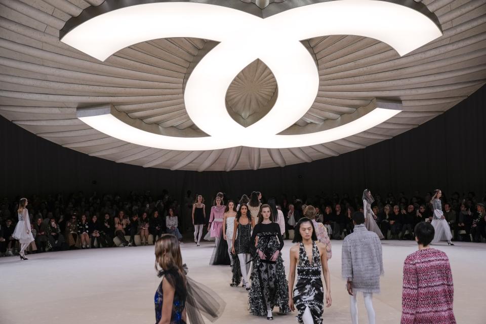 Models wear creations for Chanel as part of the Haute Couture Spring-Summer 2024 collection presented in Paris, Tuesday, Jan. 23, 2024. (AP Photo/Christophe Ena)