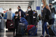 Travelers are lining up at O'Hare airport in Chicago, Friday, July 2, 2021. The U.S. set another pandemic-era record for travel on Sunday, Aug. 1, with more than 2.2 million people going through airport checkpoints. That's the biggest number in 17 months, although travel is still not quite back to pre-pandemic levels. (AP Photo/Nam Y. Huh)