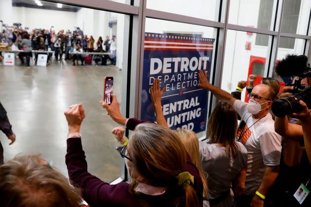 Supporters of President Donald Trump bang on the glass and chant slogans outside the room where absentee ballots for the 2020 general election were being counted on Nov. 4, 2020, in Detroit. (Photo: JEFF KOWALSKY via Getty Images)