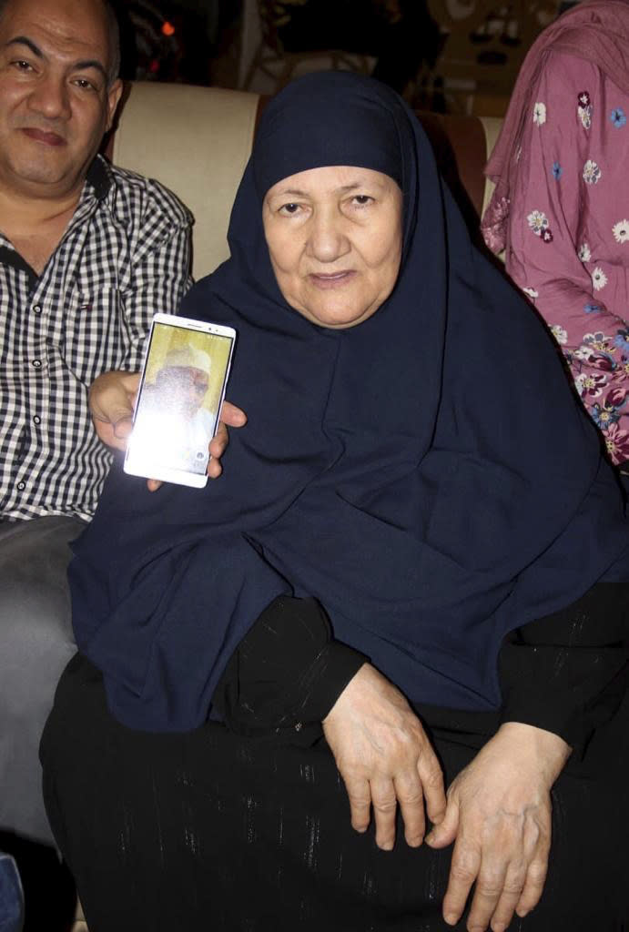 This undated handout image provided by the family of El-Sayed, shows Ghaliya Abdel-Wahab, who died from COVID-19 on April 6, 2020, posing for a photograph, in Shubra el-Kheima neighborhood, Qalyoubiya governorate, Egypt. (El-Sayed family via AP)