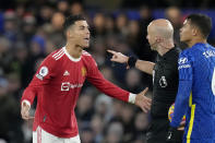 Manchester United's Cristiano Ronaldo talks to Referee Anthony Taylor while Chelsea's Thiago Silva, right, looks on during the English Premier League soccer match between Chelsea and Manchester United at Stamford Bridge stadium in London, Sunday, Nov. 28, 2021. (AP Photo/Kirsty Wigglesworth)