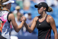 Madison Keys, right, of the United States, shakes hands with Elena Rybakina, of Kazakhstan, after their match during the Western & Southern Open tennis tournament Friday, Aug. 19, 2022, in Mason, Ohio. Keys won the match. (AP Photo/Jeff Dean)