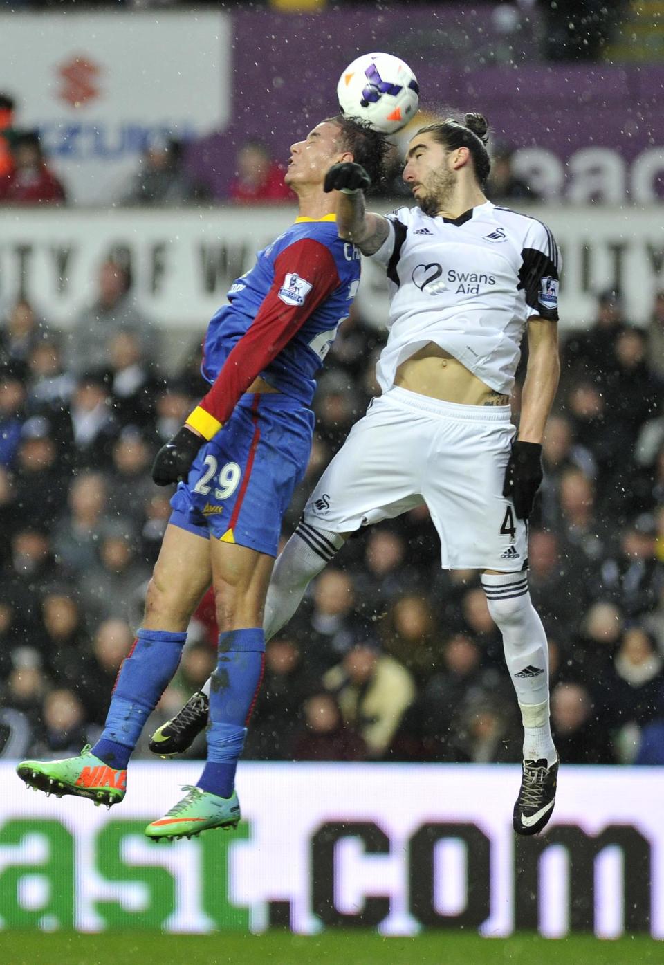 Swansea City' Chico Flores (right) and Crystal Palace's Marouane Chamakh during theEnglish Premier League match at the Liberty Stadium, Swansea, Wales, Sunday March 2, 2014. (AP Photo/PA) UNITED KINGDOM OUT NO SALES NO ARCHIVE