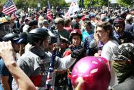 <p>An alt-right sympathizer (L) knocks the hat off an opponent’s head as alt-right activists, anti-fascist protesters, and people on all sides of the political spectrum gather for a campaign rally organized by right-wing organizer, Patriot Prayer founder and Republican Senate candidate Joey Gibson in Portland, Ore., Aug. 4, 2018. (Photo: Thomas Patterson/AFP/Getty Images) </p>