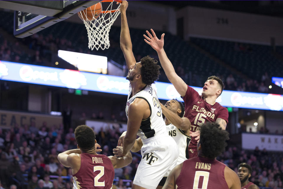 Wake Forest's Olivier Sarr (30) dunks over Florida State players in the first half of an NCAA college basketball game Wednesday, Jan. 8, 2020 in Winston-Salem, N.C. (AP Photo/Lynn Hey)
