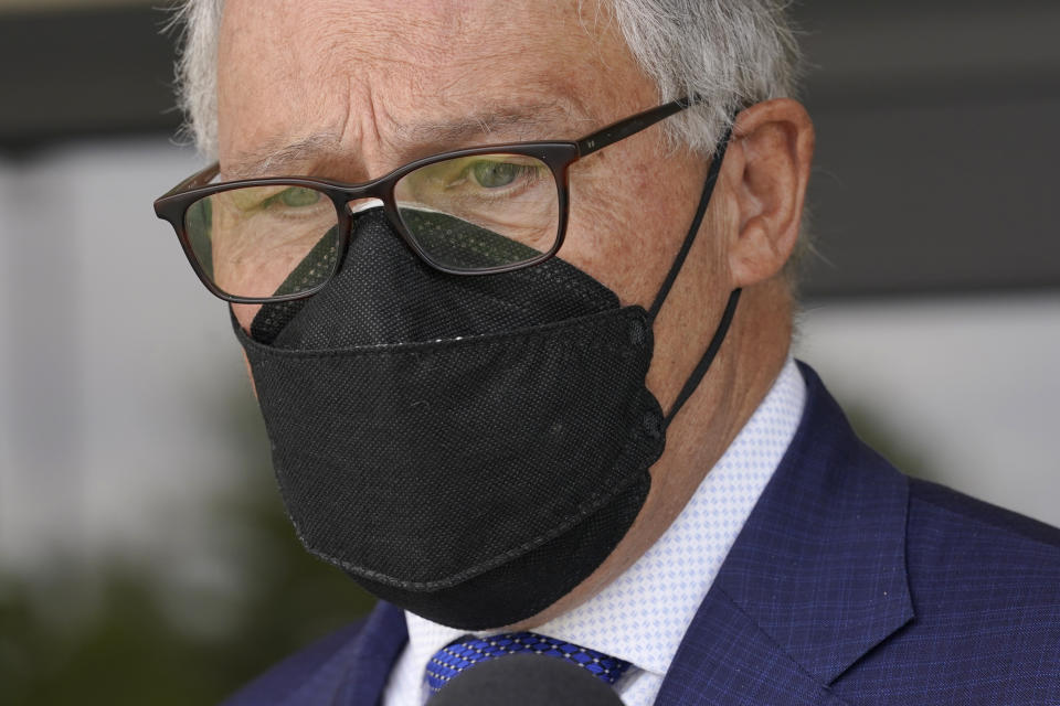 Washington Gov. Jay Inslee wears a mask as he talks to reporters, Thursday, June 2, 2022, outside a Dept. of Ecology office in Richland, Wash. On May 25, 2022, Inslee's office said the Governor had tested positive for COVID-19. Inslee, who has recently criticized the slow pace of cleaning up the Hanford Nuclear Reservation in Washington state, was speaking ahead of a scheduled tour of the nuclear weapons production site and repeated his message that more federal money is needed to finish the job. (AP Photo/Ted S. Warren)