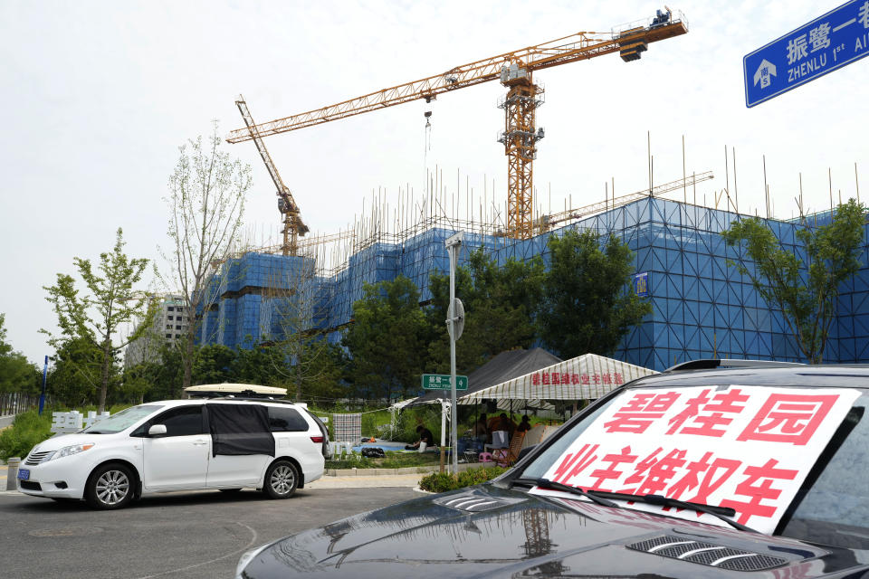 A car with a sign that reads, "Country Garden homeowners rights protections car," is parked near homeowners camping outside the Country Garden One World City project under construction on the outskirts of Beijing, Thursday, Aug. 17, 2023. China's government is trying to reassure jittery homebuyers after the major real estate developer missed a payment on its multibillion-dollar debt, reviving fears about the industry's shaky finances and their impact on the struggling Chinese economy. (AP Photo/Ng Han Guan)