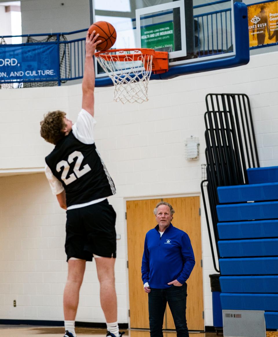 Todd Nadeau, 62, of South Lyon, at right, watches his son TJ Nadeau, 18, practice with his Novi Detroit Central Catholic basketball team on Monday, Jan. 15, 2024, at Catholic Central.