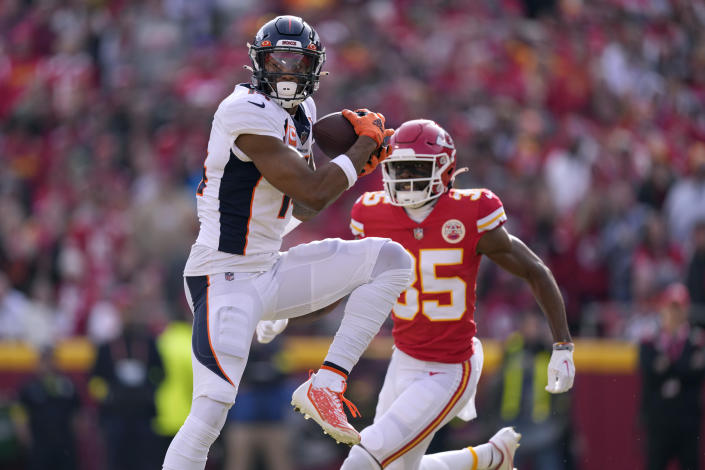 Denver Broncos wide receiver Courtland Sutton, left, catches a pass as Kansas City Chiefs cornerback Jaylen Watson defends during the first half of an NFL football game Sunday, Jan. 1, 2023, in Kansas City, Mo. (AP Photo/Charlie Riedel)
