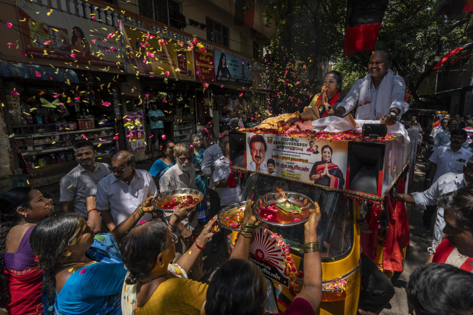 FILE- Supporters welcome Dravida Munnetra Kazhagam party candidate Thamizhachi Thangapandian, riding an open-roofed tuk-tuk, during an election roadshow in Chennai, in the southern Indian state of Tamil Nadu, April 15, 2024. (AP Photo/Altaf Qadri)