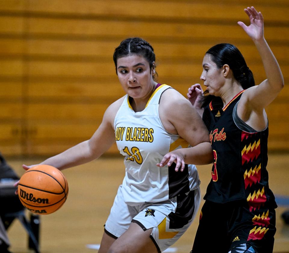 Golden West's Danae Banuelos drives against Tulare Union's Jocelynn Melendez in a non-league girls basketball game on Thursday, December 14, 2023.
