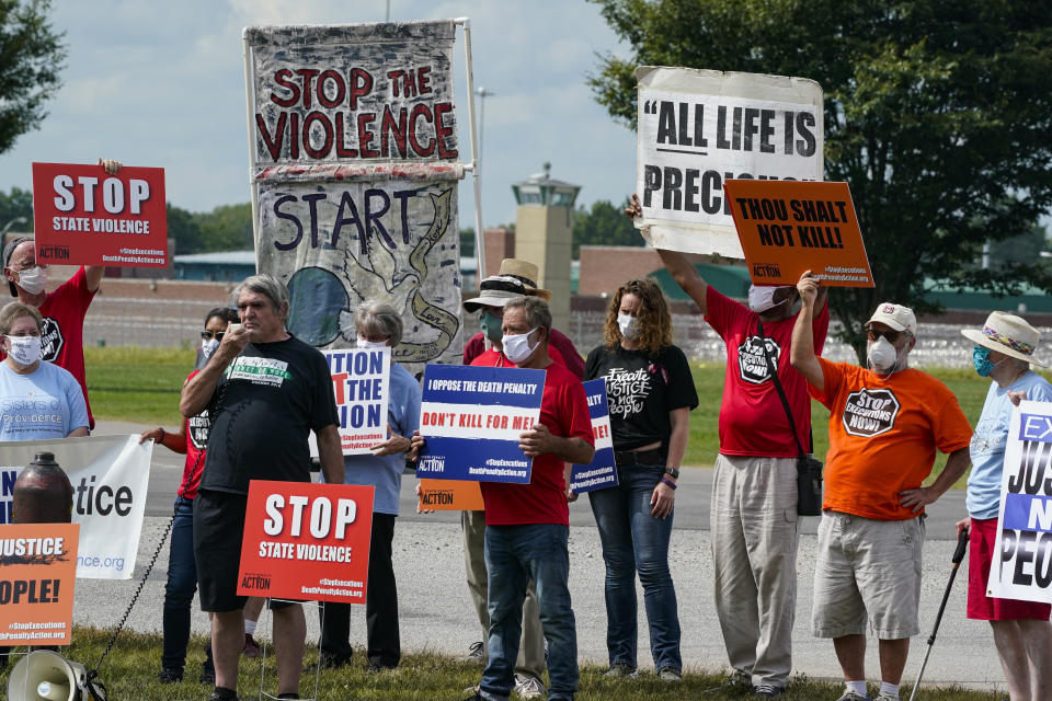 Protestors gather across from the the federal prison complex in Terre Haute, Ind., Friday, Aug. 28, 2020. Keith Dwayne Nelson, who was convicted of kidnapping, raping and murdering at 10-year-old Kansas girl, is scheduled to be executed Friday. (AP Photo/Michael Conroy)