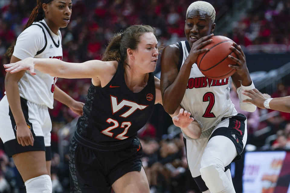 Louisville guard Yacine Diop (2) drives against Virginia Tech guard Cayla King (22) during the first half of a women's NCAA college basketball game, Sunday, March 1, 2020, at the KFC YUM Center in Louisville, Ky. (AP Photo/Bryan Woolston)