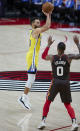 Golden State Warriors guard Stephen Curry shoots a 3-point basket over Portland Trail Blazers guard Damian Lillard during the first half of an NBA basketball game in Portland, Ore., Wednesday, March 3, 2021. (AP Photo/Craig Mitchelldyer)