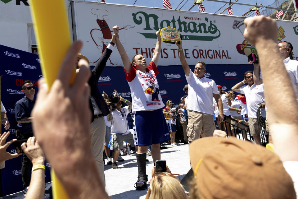 FILE - Joey Chestnut, center left, celebrates winning the Nathan's Famous Fourth of July hot dog eating contest in Coney Island on July 4, 2022, in New York. Organizers announced on Tuesday, June 11, 2024, that Chestnut won’t compete in this year’s competition due to a contract dispute. (AP Photo/Julia Nikhinson, File)