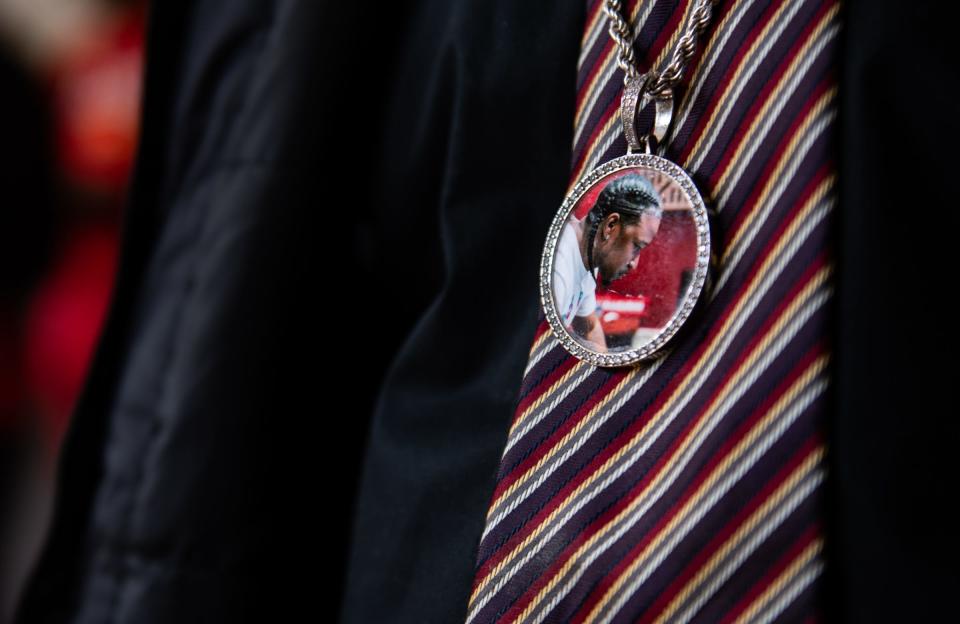 Eric Ware of Lansing, wears a pendant with a photo of his late friend, Curshawn "Kaz" Terrell, during Anthony Anderson Jr.'s trial for murder and assault, Thursday, April 18, 2024 at Veteran's Memorial Courthouse in Lansing.