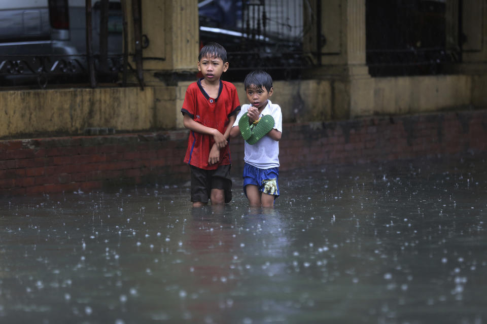 Filipino boys stand in storm