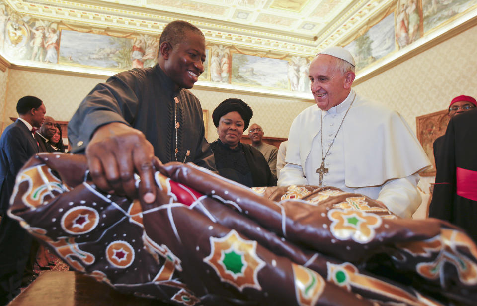 Pope Francis exchanges gifts with Nigerian President Goodluck Jonathan, left, and his wife Patience, during a private audience at the Vatican, Saturday, March 22, 2014. (AP Photo/Tony Gentile, Pool)