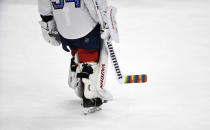 Florida Panthers goaltender Alex Lyon (34) warms up while celebrating Pride Night with a colorful hockey stick before playing the Toronto Maple Leafs, Thursday, March 23, 2023, in Sunrise, Fla. (AP Photo/Michael Laughlin)