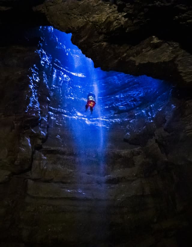 A potholer is winched into Gaping Gill (Danny Lawson/PA)