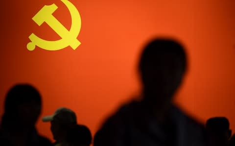 This picture taken on October 10, 2017 shows a party flag of the Chinese Communist Party displayed at an exhibition showcasing China's progress in the past five years at the Beijing Exhibition Center. - Credit: AFP