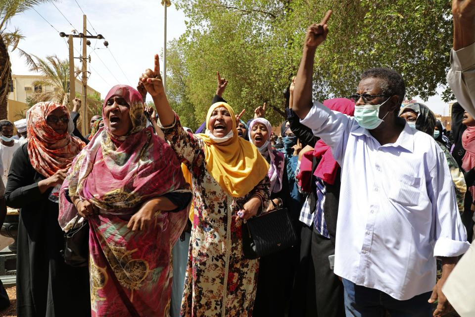 Family members of ousted Sudanese President Omar al-Bashir and over two dozen top officials in his government, protest outside a courthouse where they are on trial, in Khartoum, Sudan, Tuesday, July 21, 2020. The 76-year-old al-Bashir has been jailed in Khartoum since his ouster, facing several separate trials related to his rule and the uprising that helped oust him. Al-Bashir is also wanted by the International Criminal Court on charges of war crimes and genocide linked to the Darfur conflict in the 2000s. (AP Photo/Marwan Ali)