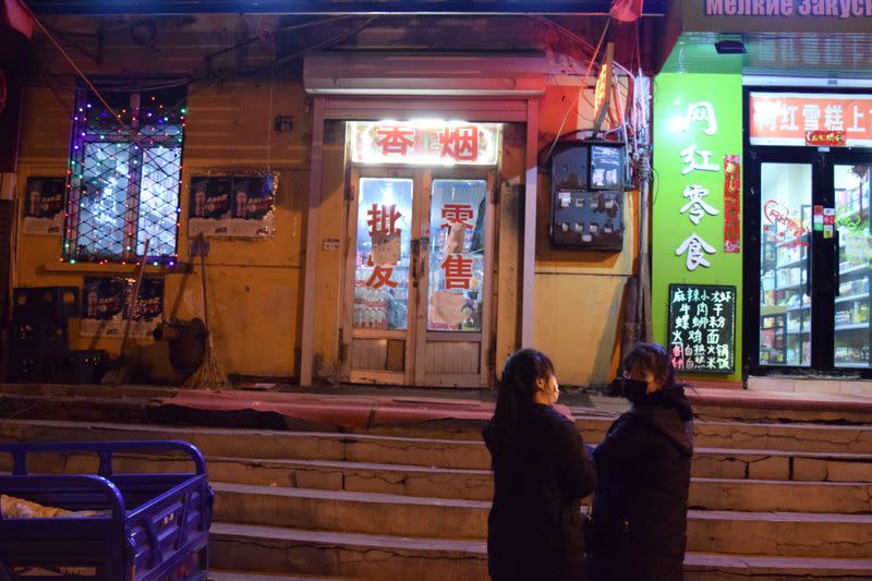 People wearing face masks are seen in the city centre of Suifenhe, a city of Heilongjiang province on the border with Russia, as the spread of coronavirus disease (COVID-19) continues in the country