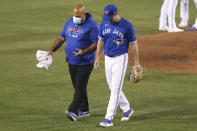 Toronto Blue Jays pitcher Ross Stripling walks off the field after being hit by a ball batted by Baltimore Orioles' DJ Stewart during the eighth inning of a baseball game Saturday, Sept. 26, 2020, in Buffalo, N.Y. (AP Photo/Jeffrey T. Barnes)