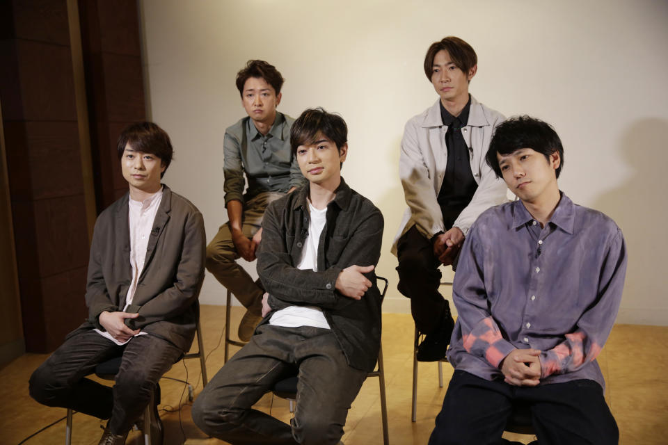 Members of Japanese pop music band ARASHI listen to a question during an interview with The Associated Press in Tokyo on Thursday, Sept. 17, 2020. Back row, from left, clockwise, are Satoshi Ohno, Masaki Aiba, Kazunari Ninomiya, Jun Matsumoto and Sho Sakurai. The Japanese pop sensation group has a big surprise for fans as they near their planned hiatus at year's end: a collaboration with Bruno Mars on their first all-English single. (AP Photo/Hiro Komae)