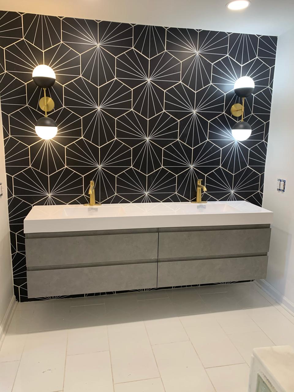 Look how these fun light fixtures really accentuate the wallpaper and modern cabinetry. Switching out dated fixtures is an easy and inexpensive way to add pizazz to any room.