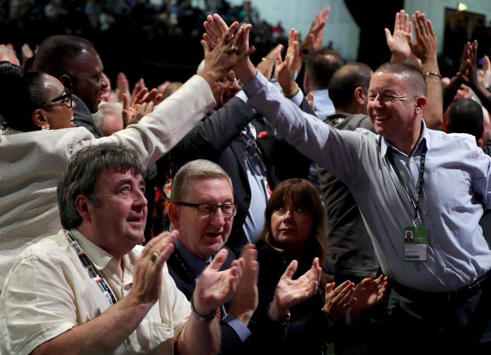 Delegates react during voting on Labour's Brexit policy during the Labour Party Conference at the Brighton Centre in Brighton.