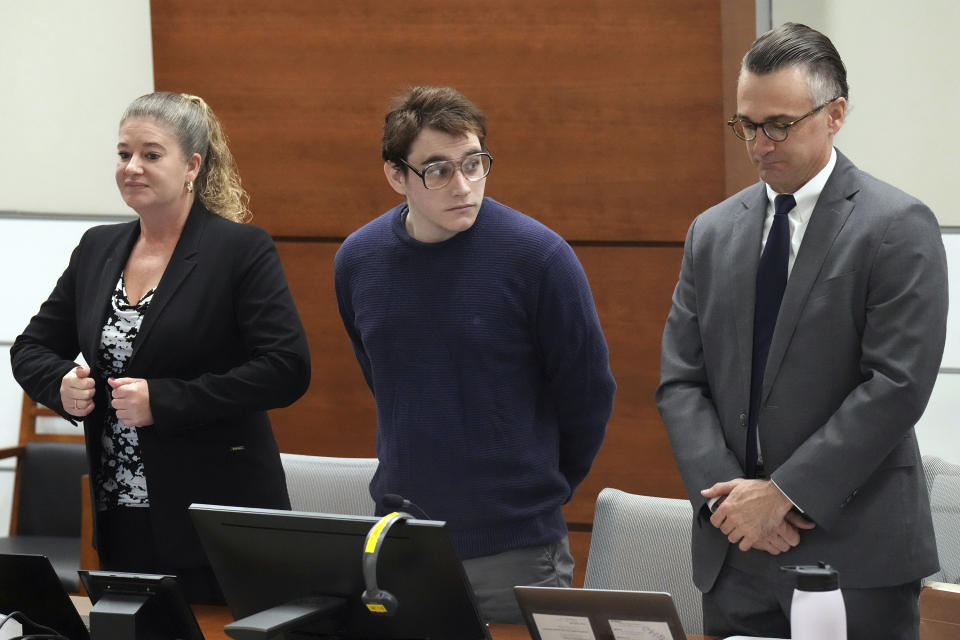 Marjory Stoneman Douglas High School shooter Nikolas Cruz, center, looks towards where the victims' families are seated as he stands with his defense team during the penalty phase of Cruz's trial at the Broward County Courthouse in Fort Lauderdale, Fla. on Tuesday, Sept. 27, 2022. Cruz previously plead guilty to all 17 counts of premeditated murder and 17 counts of attempted murder in the 2018 shootings. (Amy Beth Bennett/South Florida Sun Sentinel via AP, Pool)