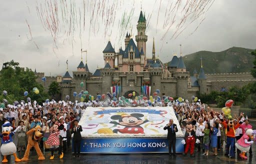 This file photo shows Hong Kong Disneyland staff as they celebrate the theme park's first anniversary, in 2006. Hong Kong's struggling Disneyland has posted its first profit since opening seven years ago thanks to an increase in mainland Chinese visitors, as it considers opening new hotels